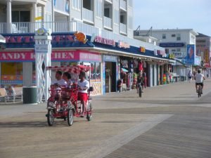 bikes on the boardwalk with candy kitchen in background