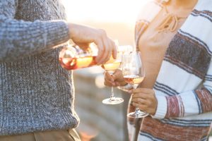 Couple drinking wine on the beach