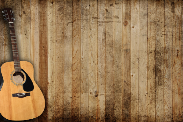 Acoustic Guitar On Wood Panelling 1