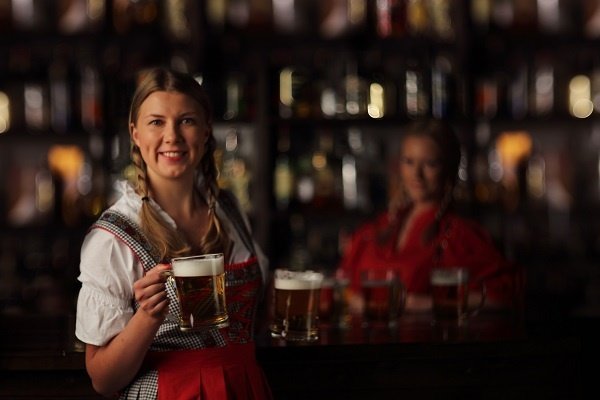 Event Octoberfest Woman With Beers And Bartender In Background