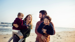 Picture of a family on the beach with kids in the fall or winter.