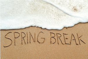 Boardwalk Hotel Group Buzz Spring Break written in sand on the beach