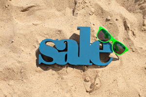 Graphic of the word "sale" on beach sand