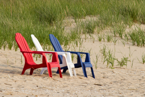 Red white and blue beach chairs on the sand