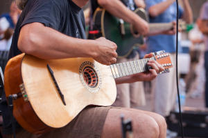 Man playing guitar in a band